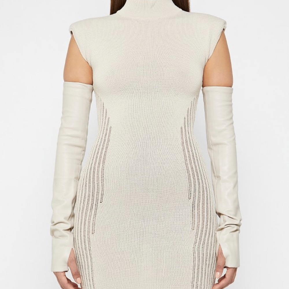 A mini knitted dress with leather arm sleeves.